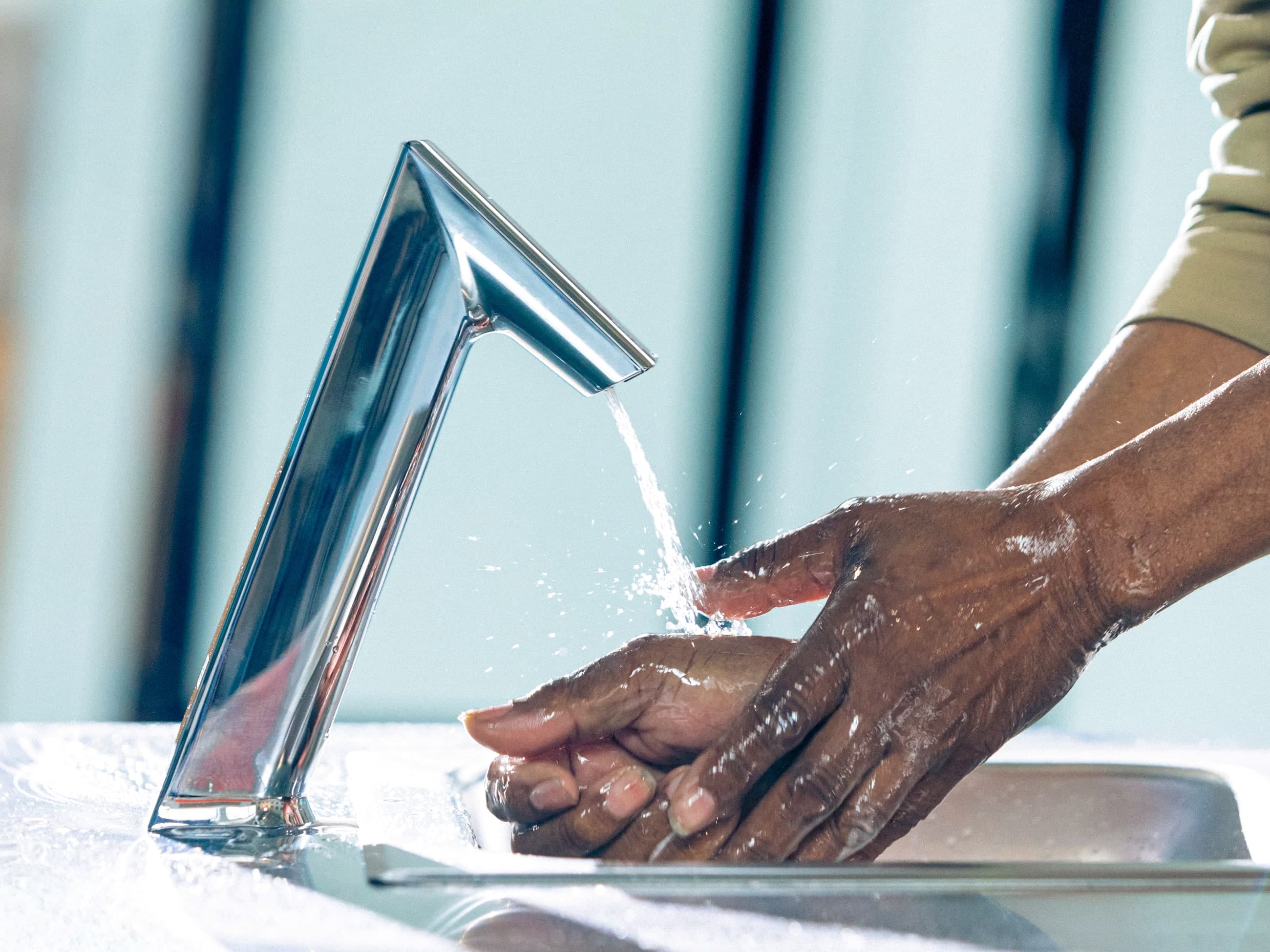 Man washing hand with a Sloan BASYS® Faucet.