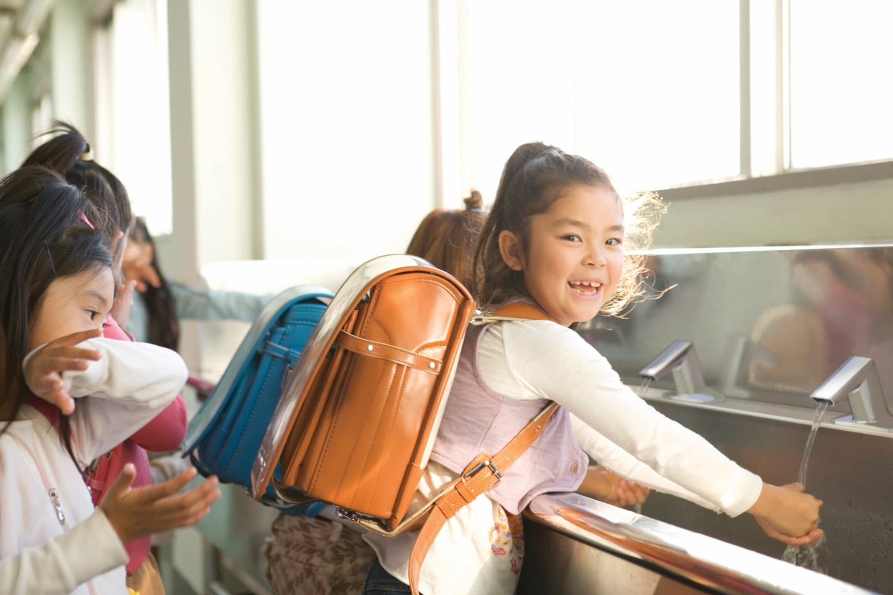 Children washing their hands at school