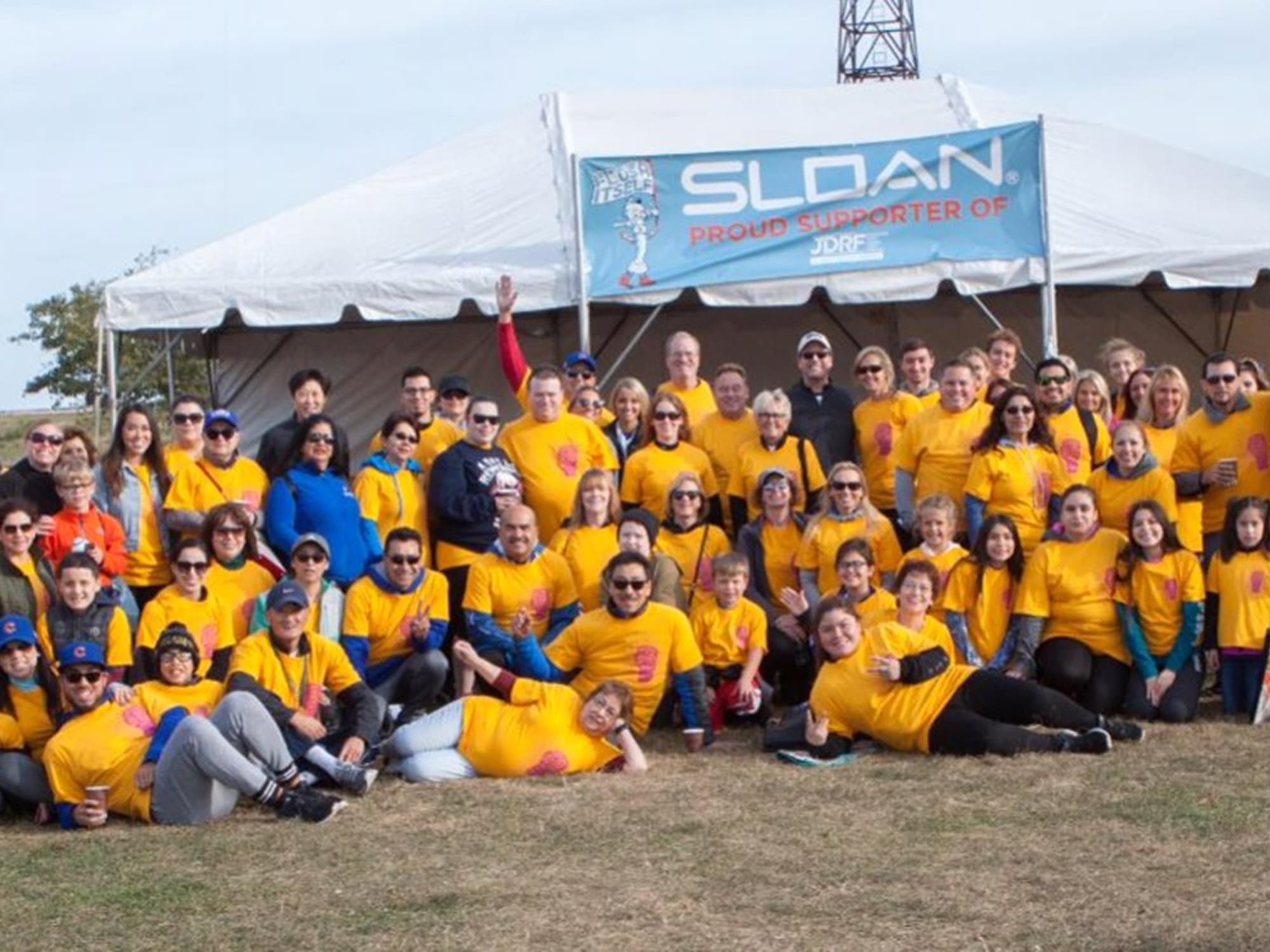 Sloan team members wearing yellow shirts at a JDRF community event supporting type 1 diabetes research