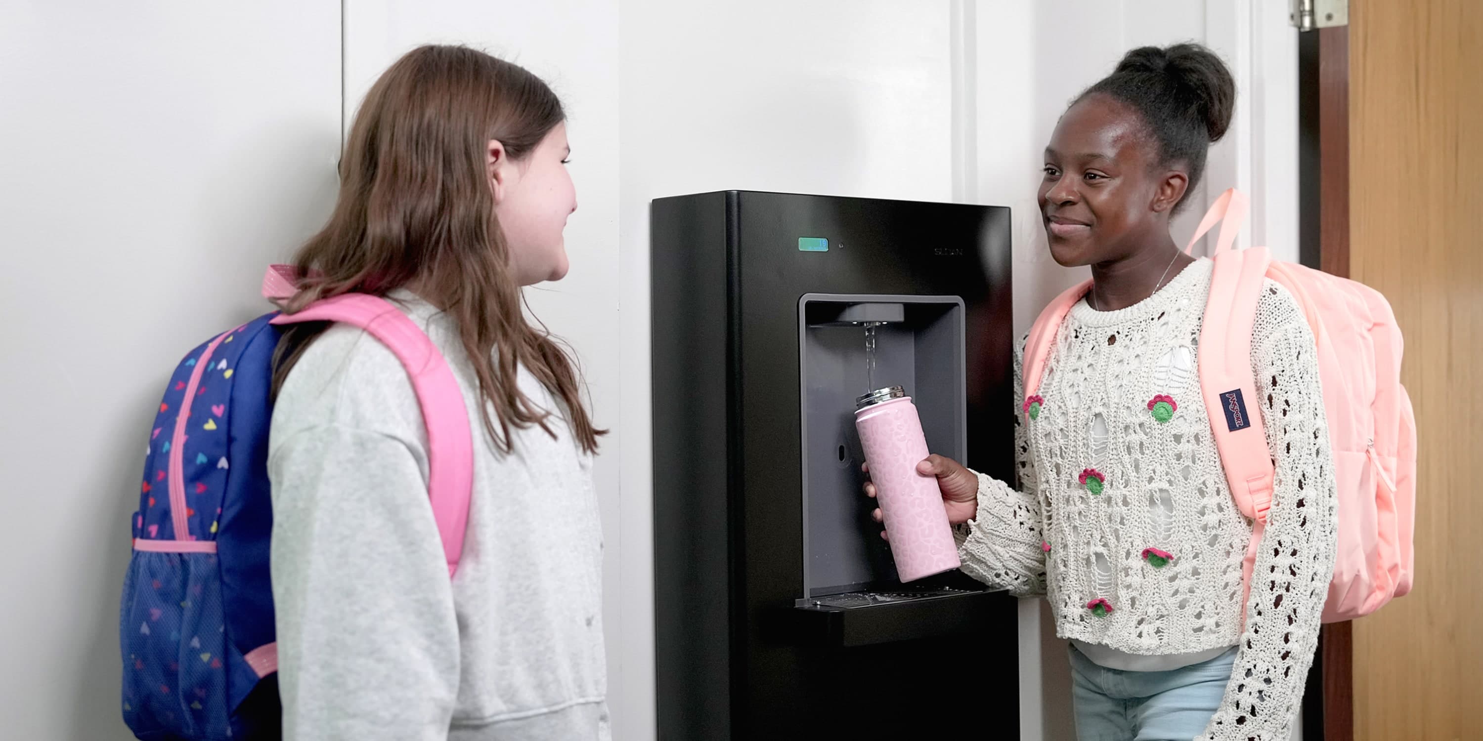 DropSpot Bottle Filler Station being used by two elementary school students