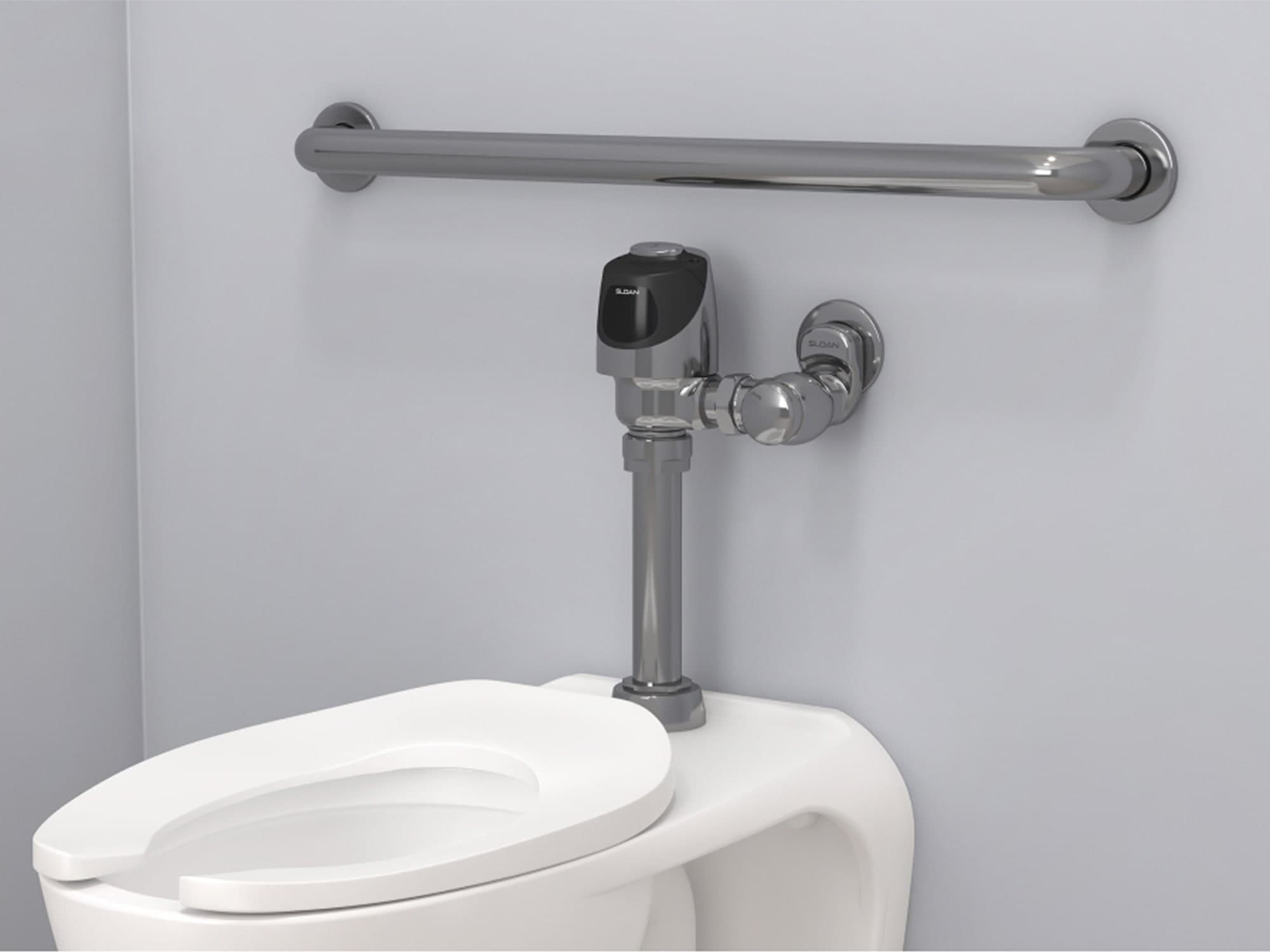 Sloan water closet with sensor flushometer and ADA compliant hand rail to assist with disabilities 