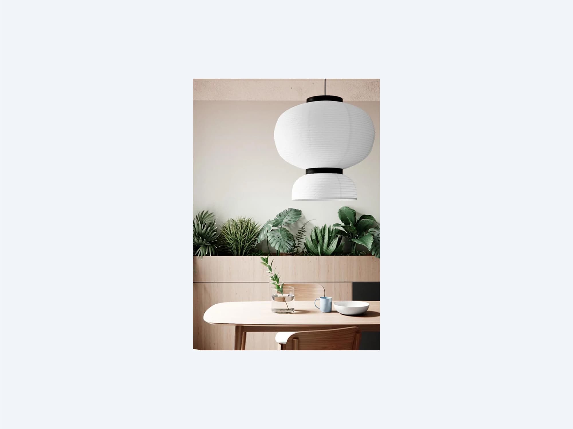 Modern interior featuring a round white pendant light over a wooden table.