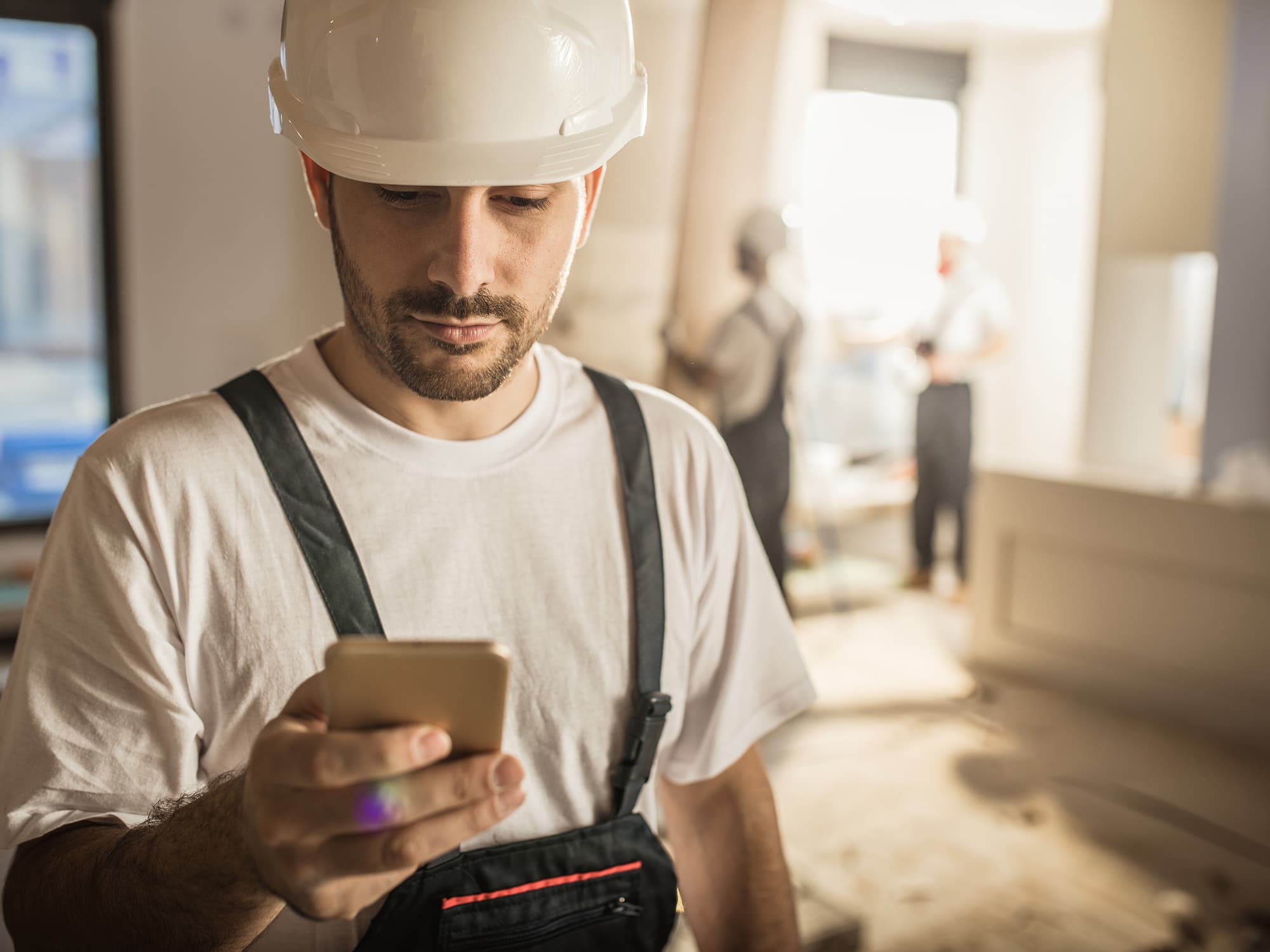 Contractor using Sloan Training Center on phone