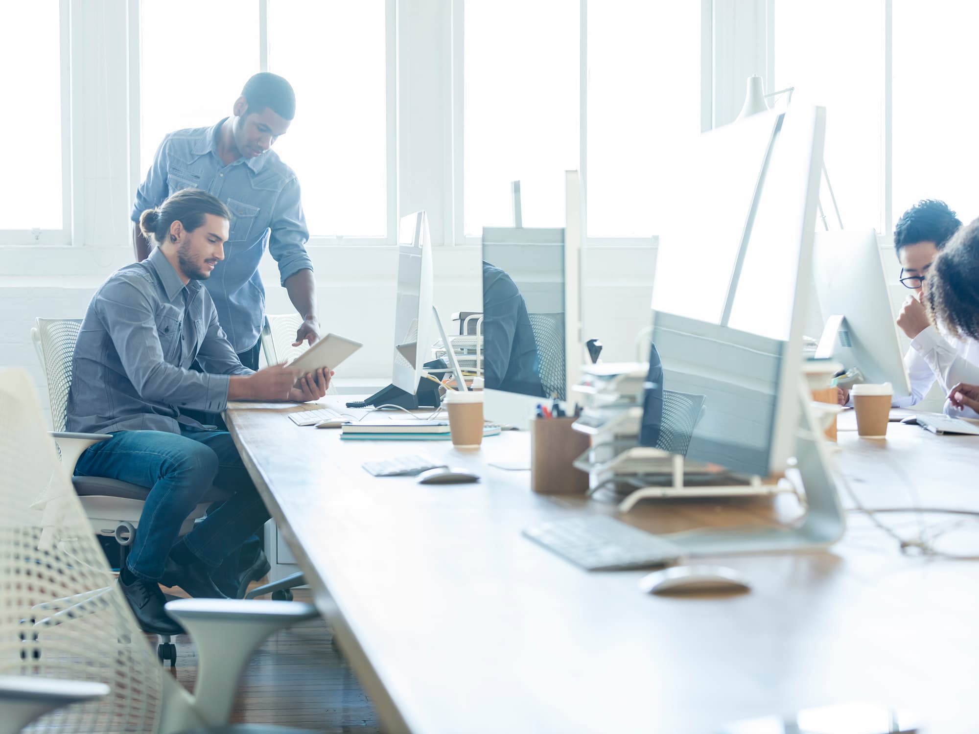 People in bright lit office for understanding WELL