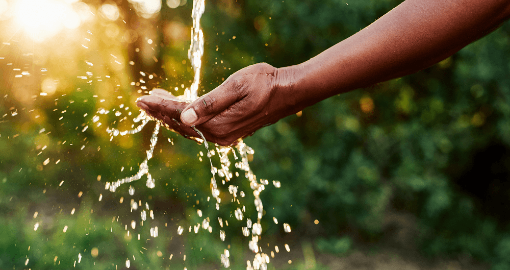 Hand under a steady flow of water