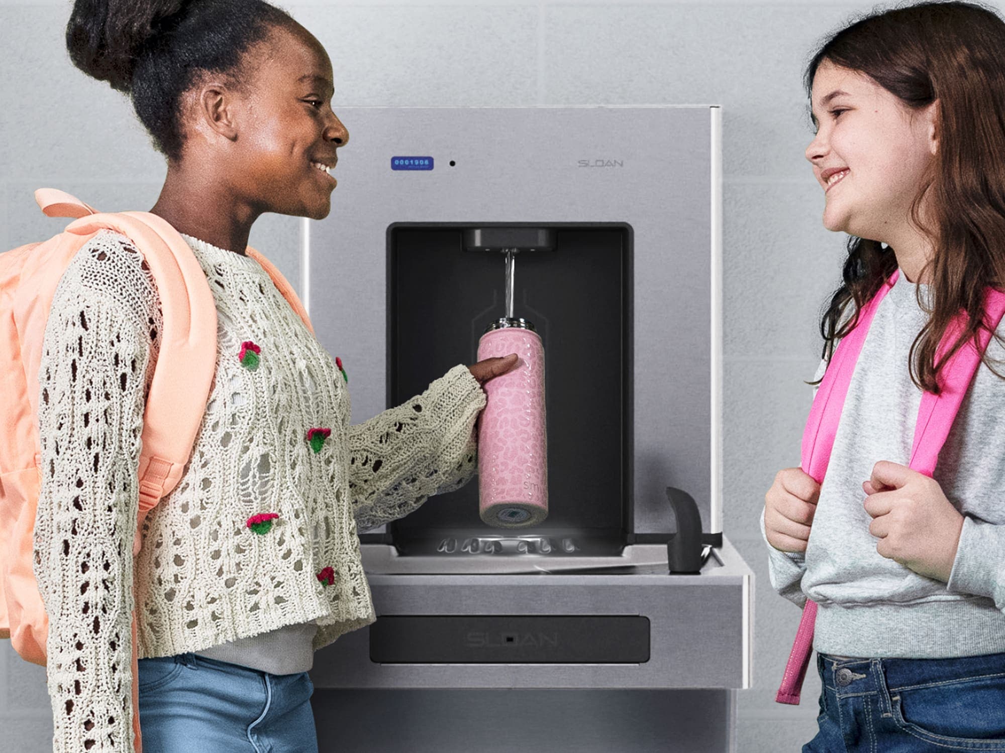 girls talking at a bottle filler station