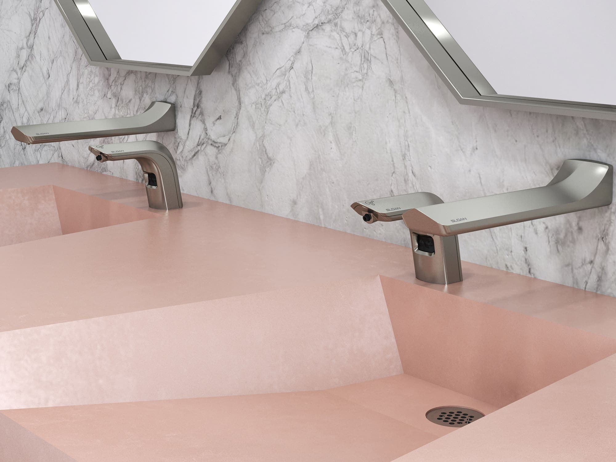 Sloan’s Designer Series™ sinks in a soft blush quartz finish, featuring integrated rectangular basins and wall-mounted sensor faucets.