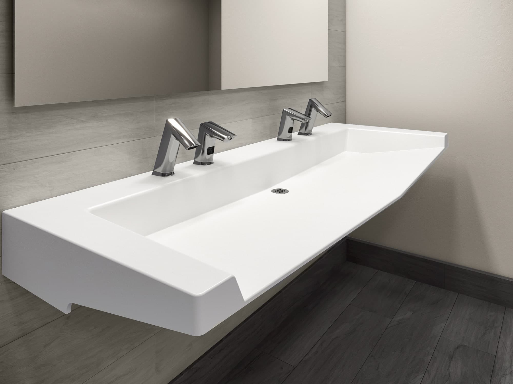 SloanStone® Quartz Arrowhead sink deck with sharp angled front edge and two chrome fixtures, installed in a modern commercial restroom.