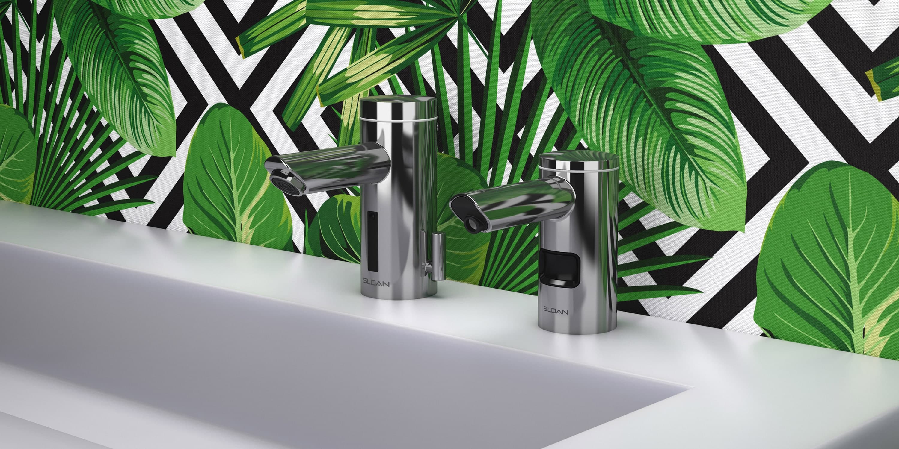 Modern stainless steel faucets installed on a white sink with a bold tropical leaf and black-and-white geometric patterned wall in the background.