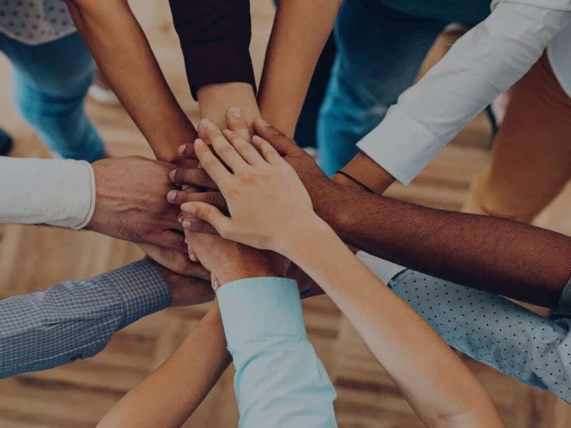 A group of hands together in a huddle