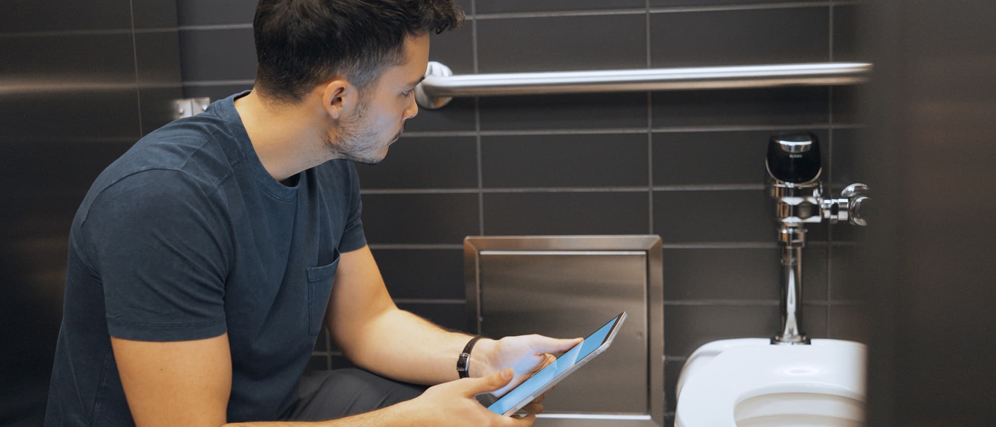 Plumbing contractor running diagnostic on Sloan flushometer