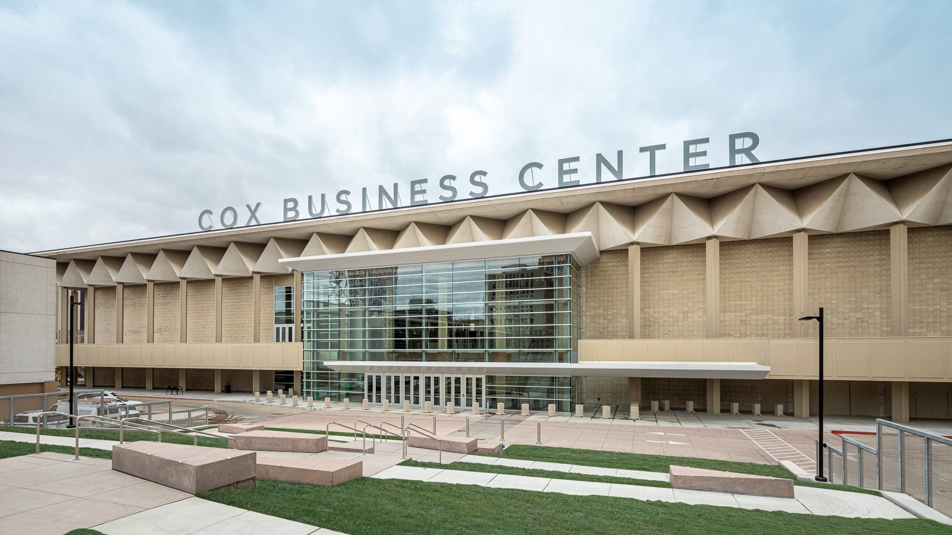 street view of cox business center tan colored building on a bright day