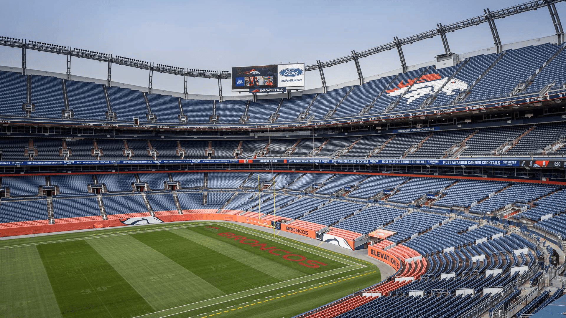 view from the benches at the Denver Broncos stadium showing the field and the other side of the stadium benches