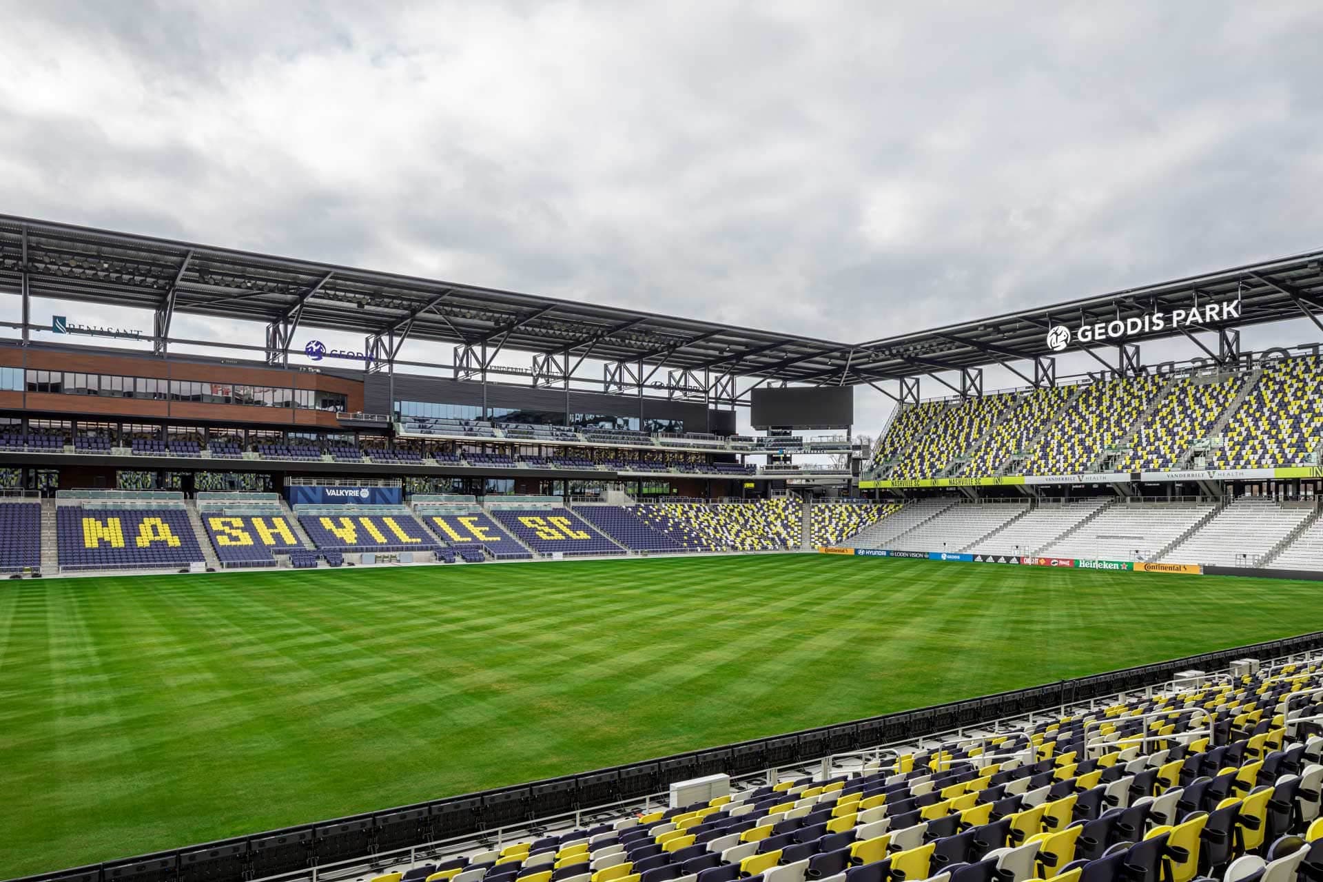 internal view of stadium featuring the green playing field and the surrounding seating areas
