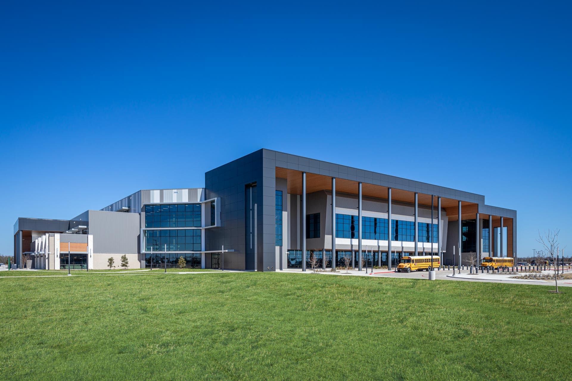 street view of school building surrounded by green grass