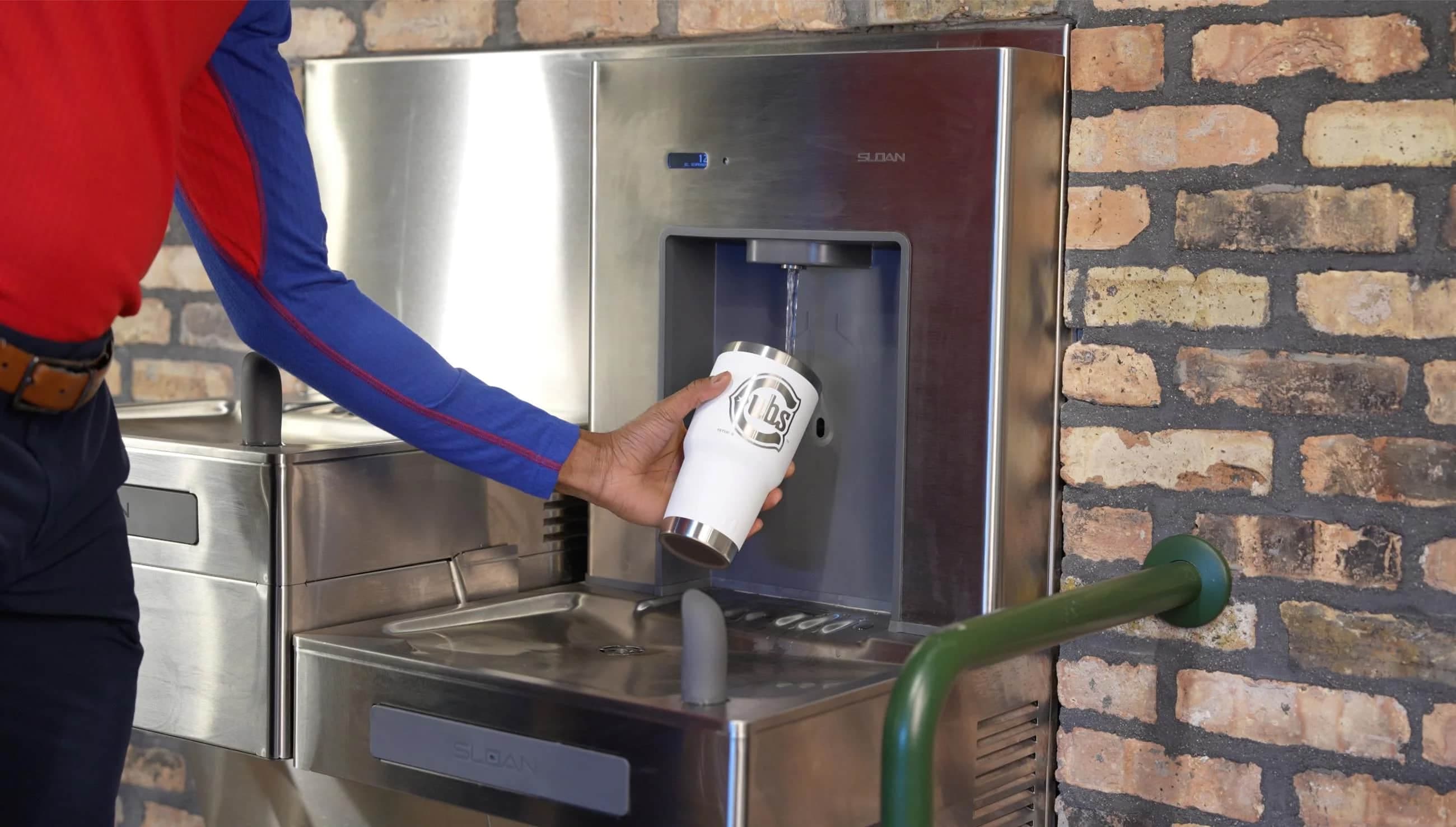 a man filling up water bottle