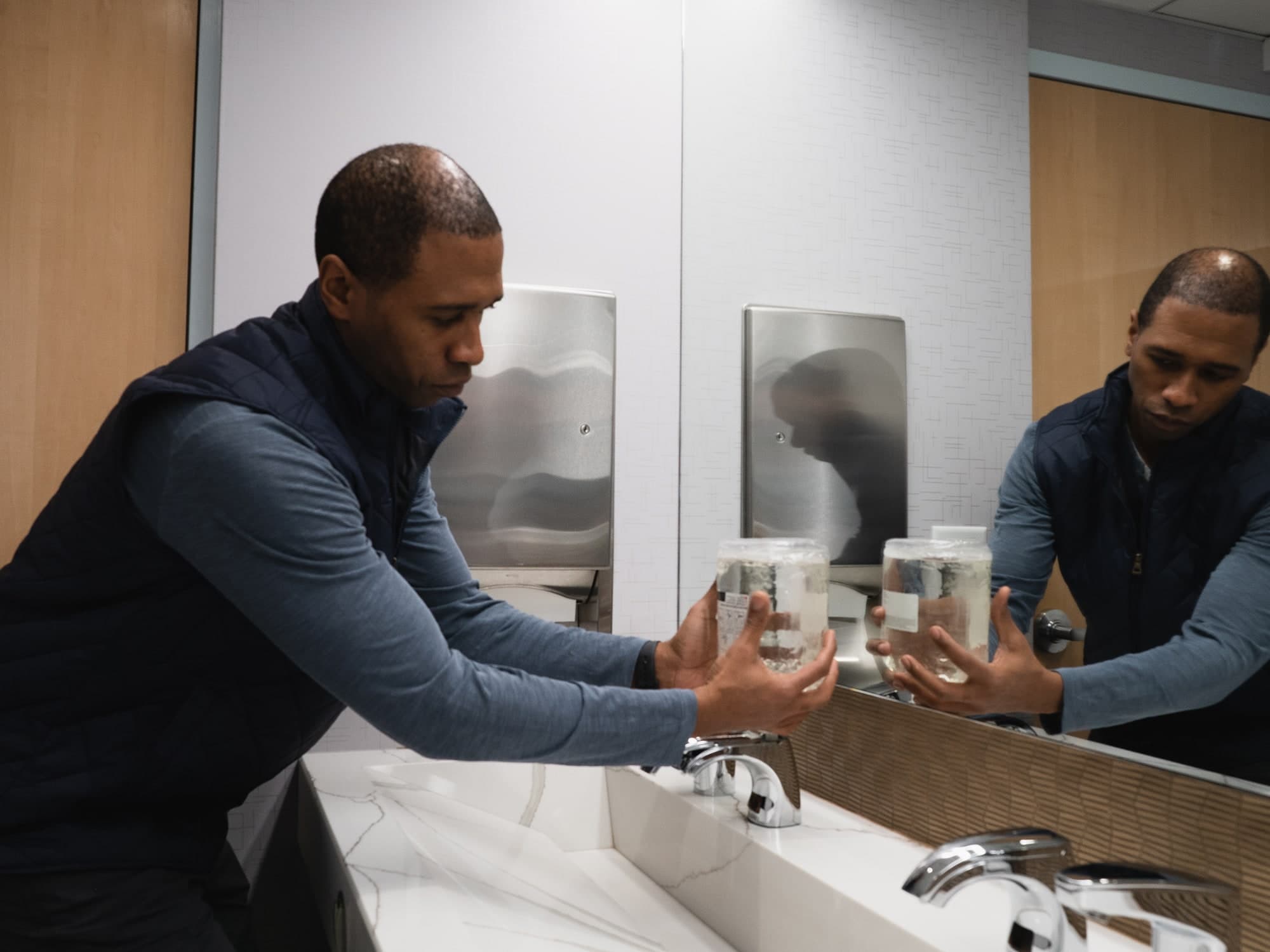 Facility manager easily refilling a Sloan Top-fill Soap Dispenser