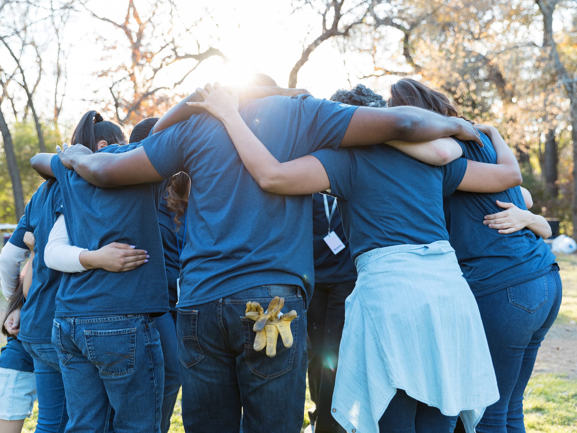 Sloan volunteers standing together with arms linked at a community service event