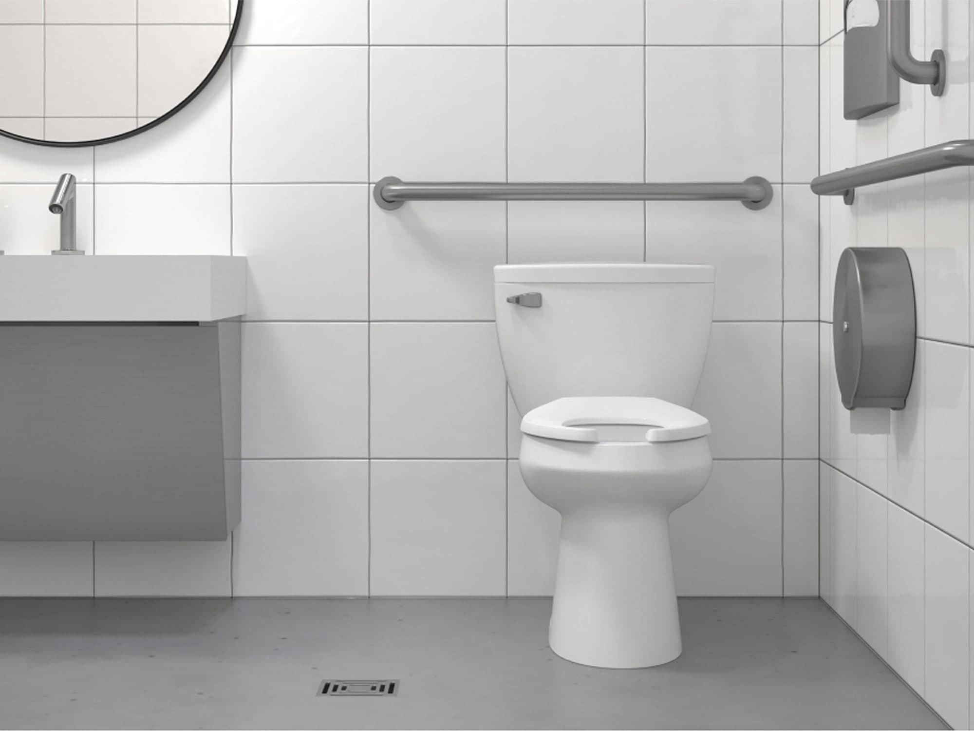 White and grey room with Sloan toilet surrounded by ADA compliant hand rails to support disabilities