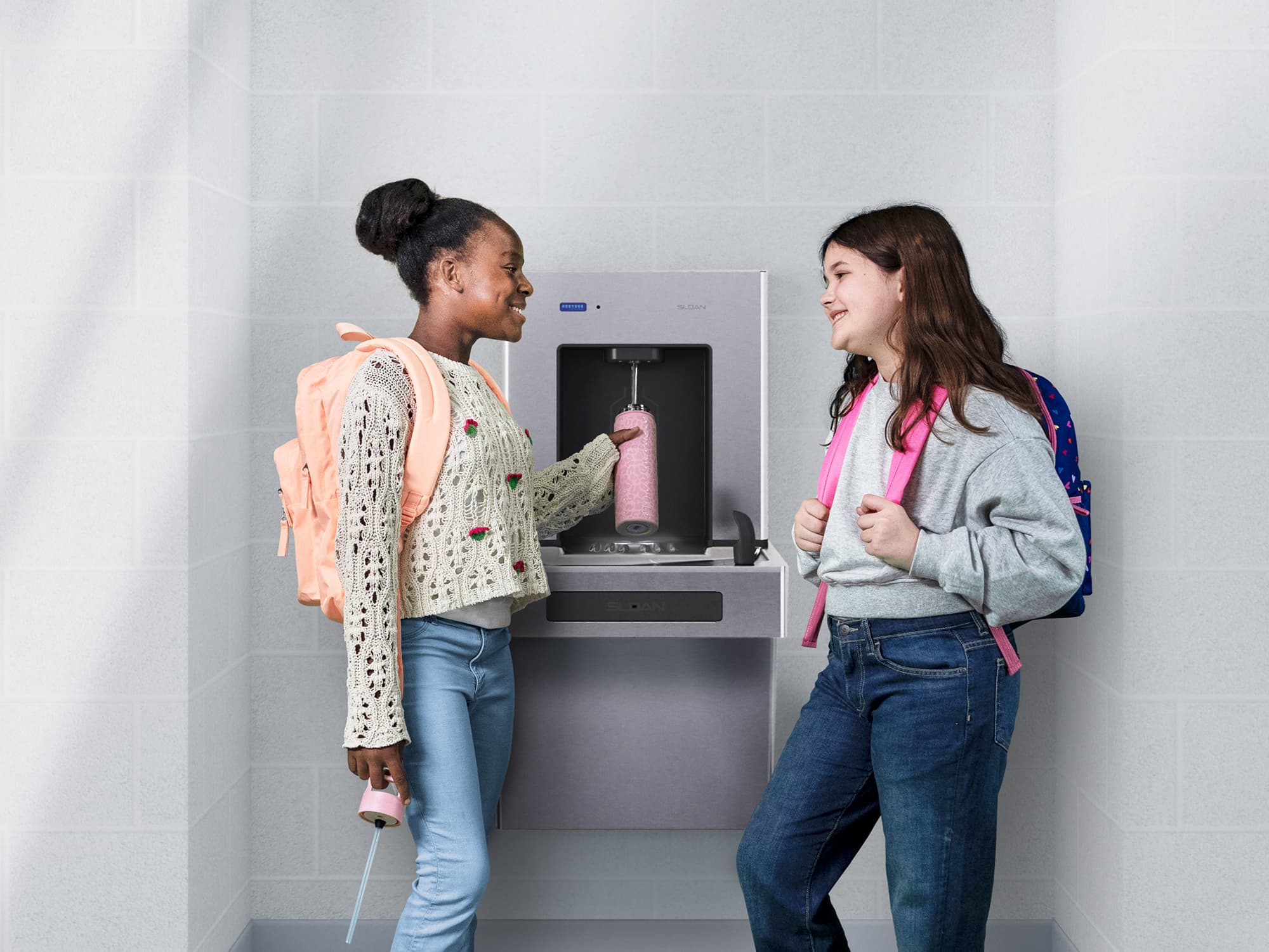 School children refilling bottles at DropSpot™ Bottle Filler station