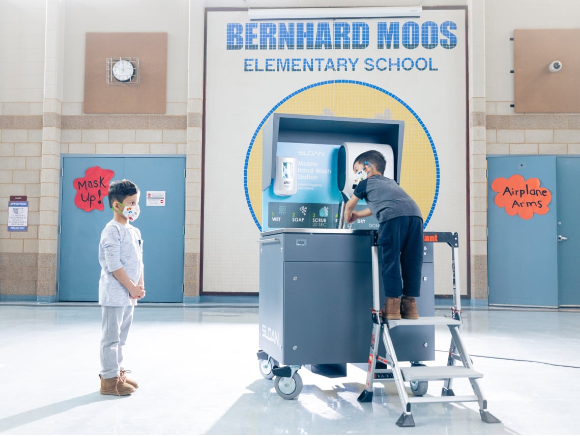 Bernhard Moos elementary students using mobile handwashing station